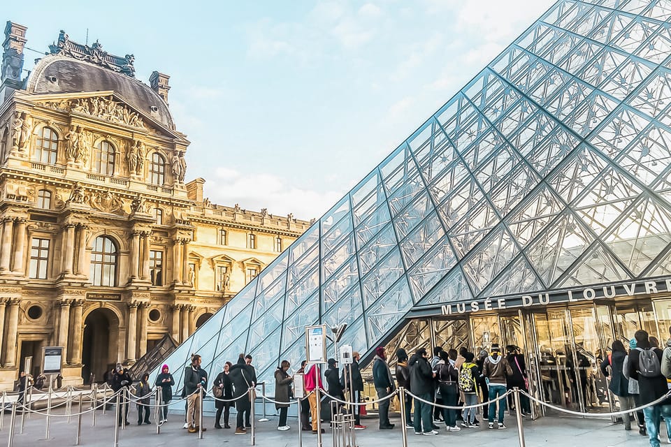 Amazing view from a Louvre Pyramid from a dark and moody day with rainy weather | SUPERPOBYT World