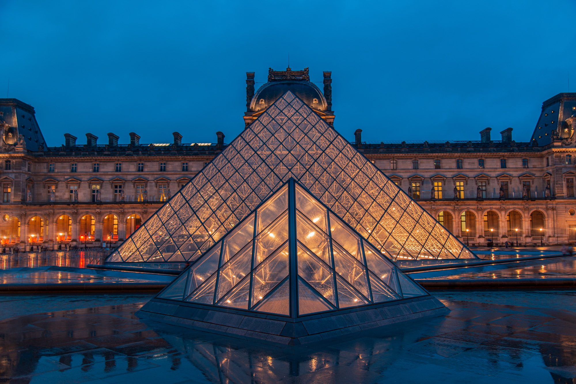 Amazing view from a Louvre Pyramid from a dark and moody day with rainy weather | SUPERPOBYT World